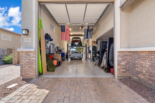 view of exterior entry featuring stucco siding and decorative driveway