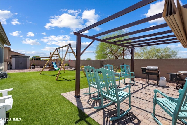 view of patio / terrace featuring an outdoor structure, grilling area, a fenced backyard, a storage shed, and a playground