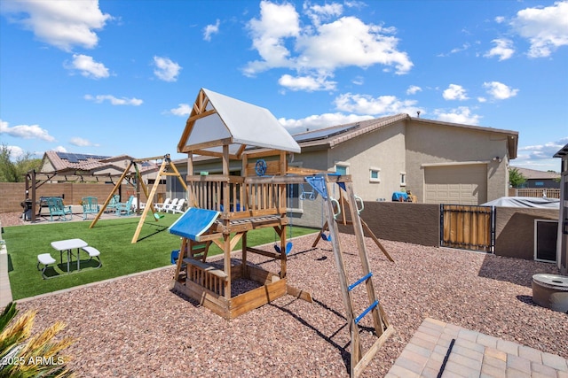 view of jungle gym featuring fence and a lawn