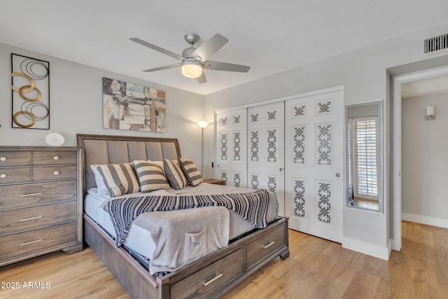 bedroom with ceiling fan, light hardwood / wood-style floors, and a closet