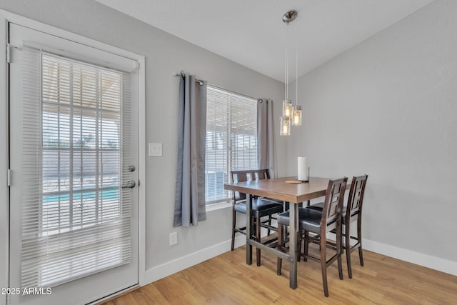 dining area featuring lofted ceiling and hardwood / wood-style floors