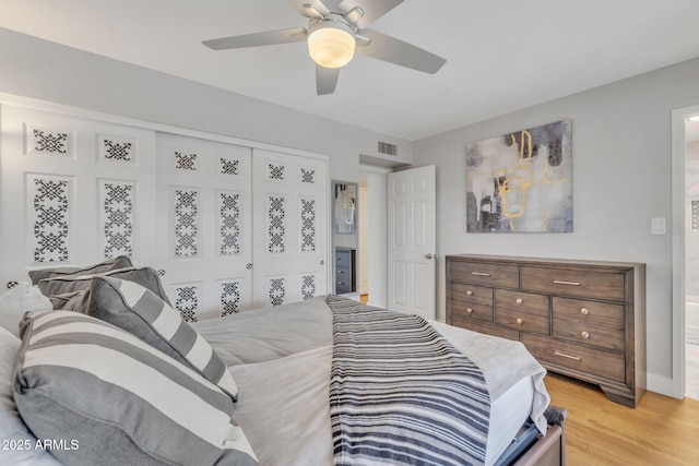 bedroom featuring a closet, ceiling fan, and light wood-type flooring