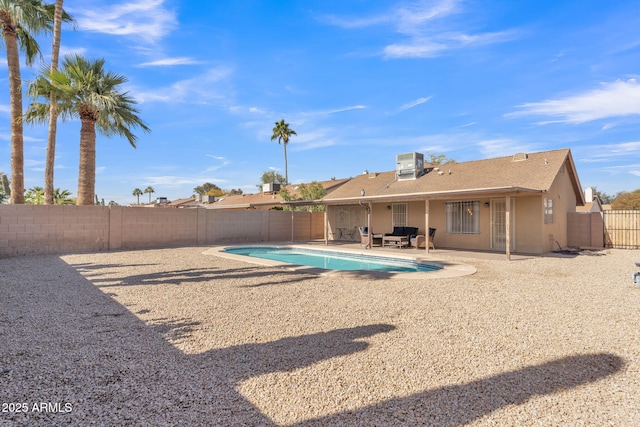 view of pool with central AC unit and a patio