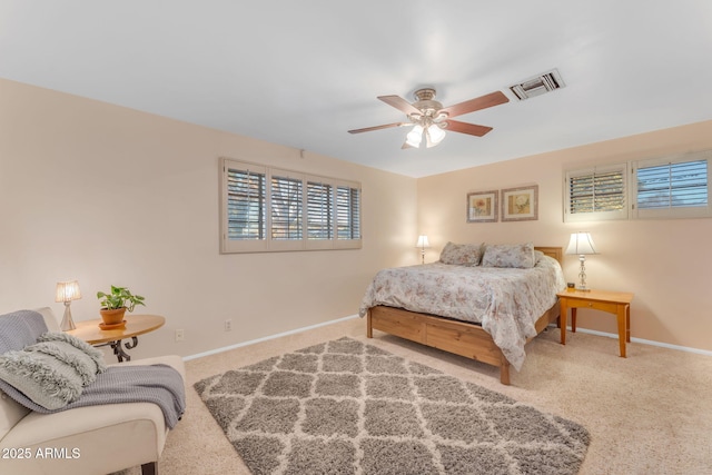 carpeted bedroom with ceiling fan, visible vents, and baseboards