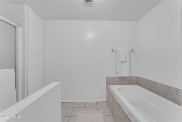 full bathroom with tile patterned flooring, visible vents, baseboards, and a bath