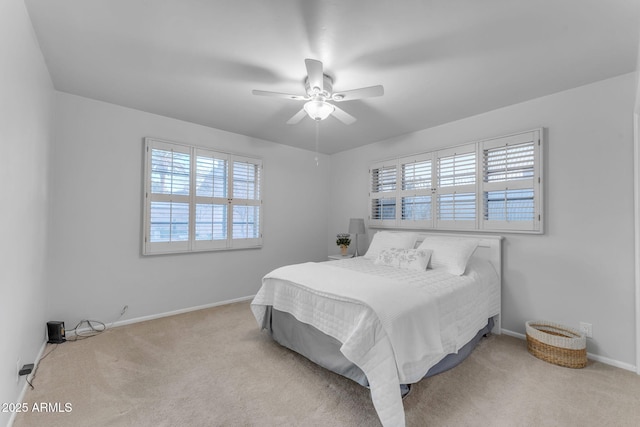 carpeted bedroom featuring ceiling fan and baseboards