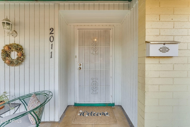 property entrance featuring concrete block siding