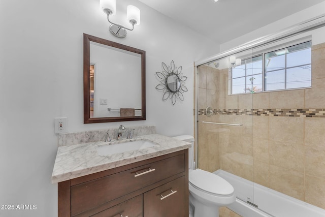 bathroom with a stall shower, vanity, and toilet