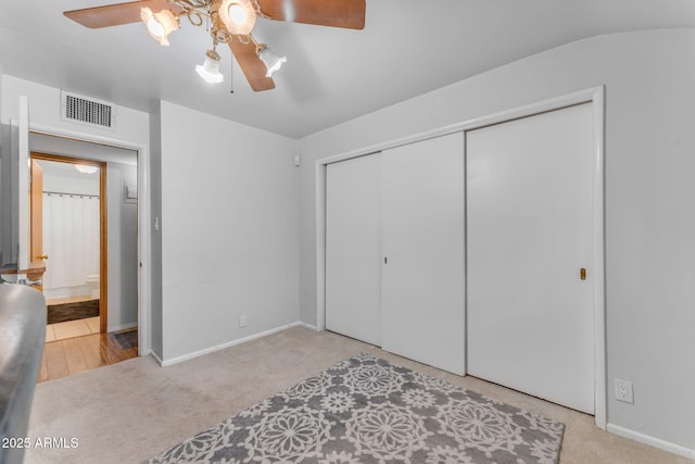 bedroom featuring ceiling fan, carpet floors, a closet, and visible vents