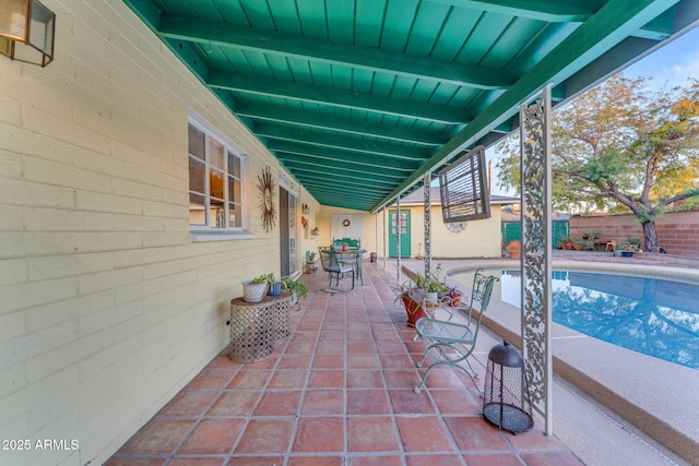 view of patio featuring a fenced in pool and fence