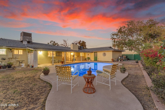 pool featuring a patio, fence, and central air condition unit