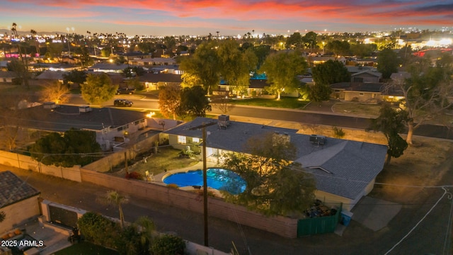 view of pool at dusk