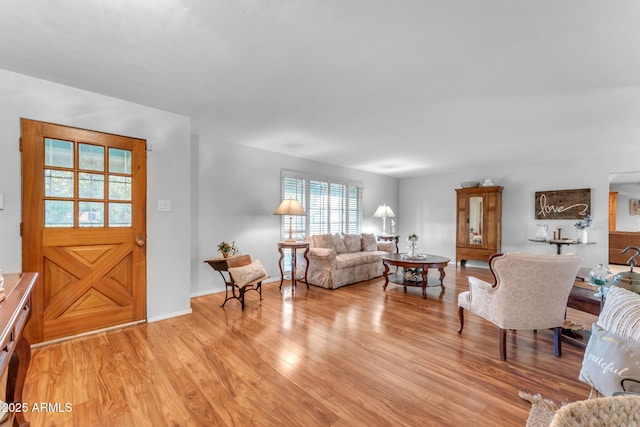 living area with light wood finished floors and baseboards