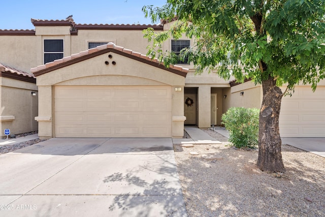 125 S 56th St Unit 27, Mesa, AZ 85206 - multi unit property featuring concrete driveway, stucco siding, a tile roof, and an attached garage