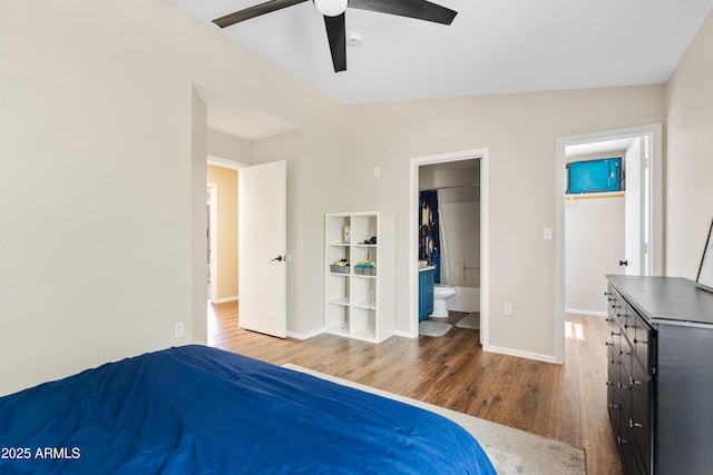 125 S 56th St Unit 27, Mesa, AZ 85206 - unfurnished bedroom with a walk in closet, wood finished floors, a closet, connected bathroom, and a ceiling fan