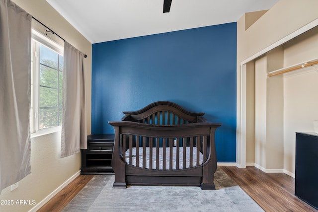 125 S 56th St Unit 27, Mesa, AZ 85206 - bedroom featuring wood finished floors, ceiling fan, and a crib
