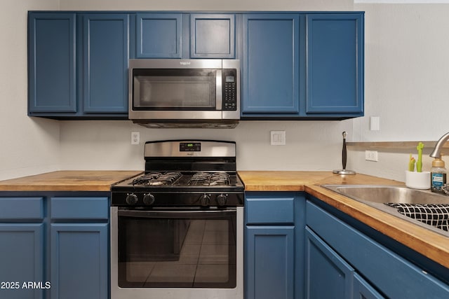 125 S 56th St Unit 27, Mesa, AZ 85206 - kitchen with stainless steel microwave, range with gas cooktop, blue cabinets, and butcher block counters