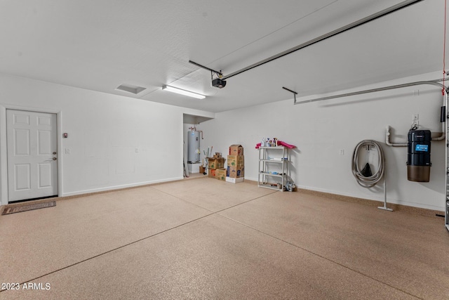 garage featuring electric water heater and a garage door opener