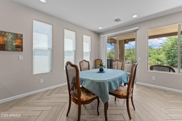 dining area featuring light parquet flooring