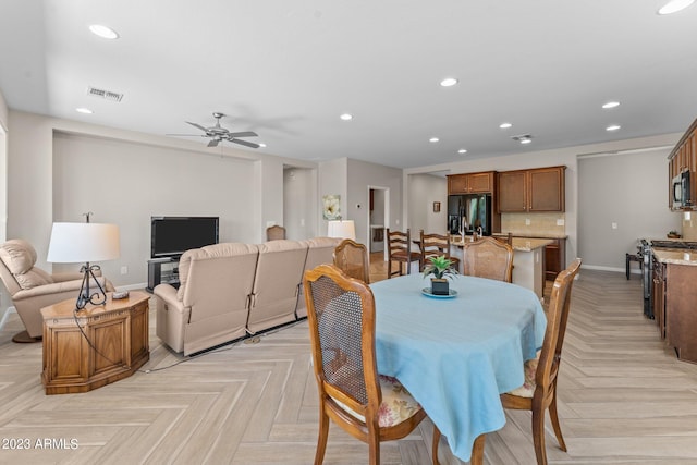 dining area featuring ceiling fan and light parquet floors