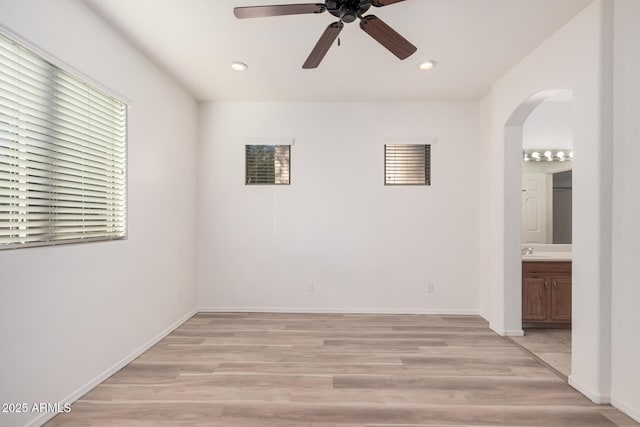 empty room with ceiling fan and light wood-type flooring