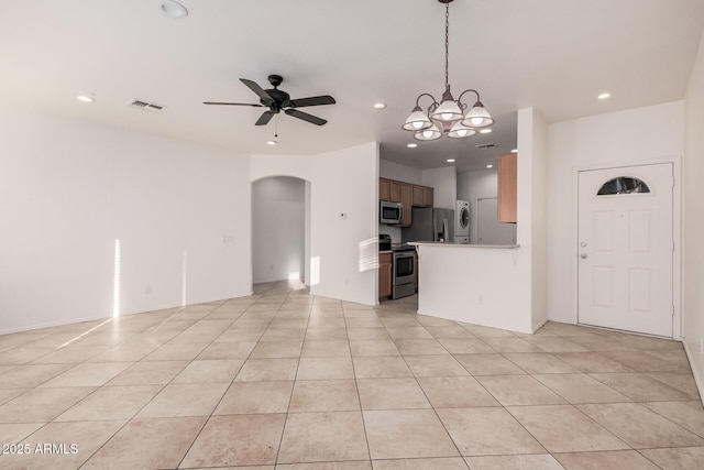 kitchen with ceiling fan, hanging light fixtures, stainless steel appliances, and light tile patterned flooring