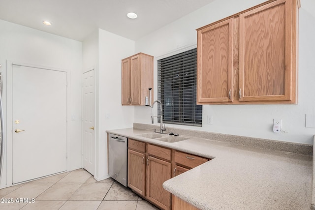 kitchen featuring sink, stainless steel dishwasher, and light tile patterned floors