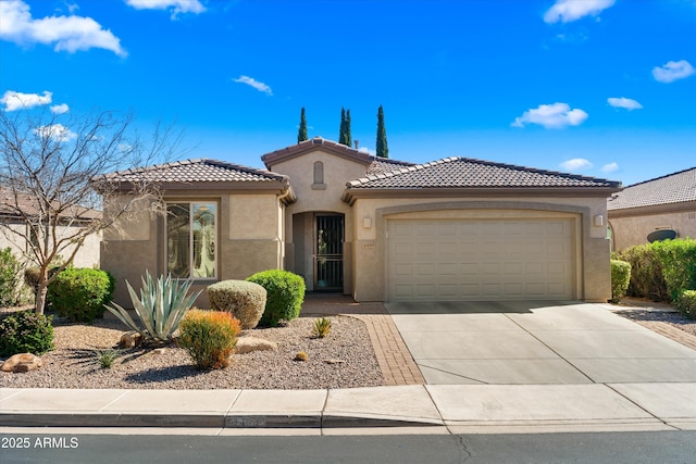 view of front of house featuring a garage, driveway, a tile roof, and stucco siding