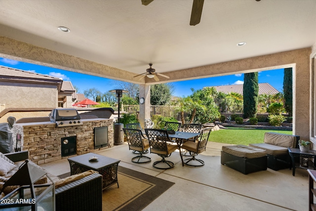 view of patio / terrace with a ceiling fan, outdoor dining space, fence, exterior kitchen, and an outdoor living space