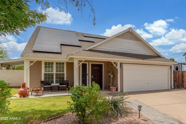 2508 N Karen Dr, Chandler, AZ 85224 - view of front of house with a shingled roof, an attached garage, roof mounted solar panels, concrete driveway, and an outdoor living space