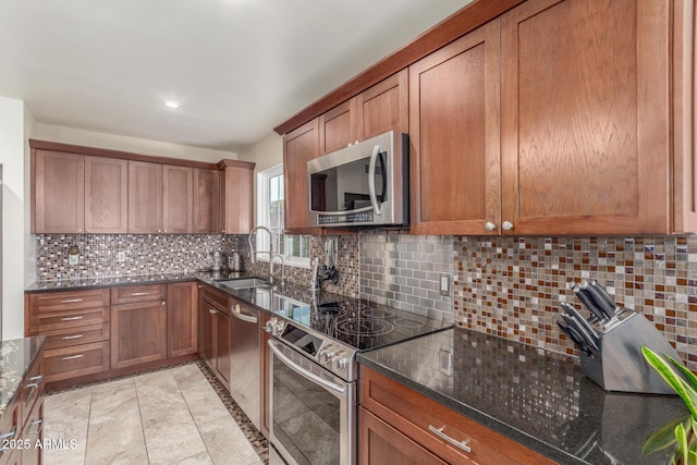 2508 N Karen Dr, Chandler, AZ 85224 - kitchen with stainless steel appliances, a sink, brown cabinetry, dark stone countertops, and recessed lighting