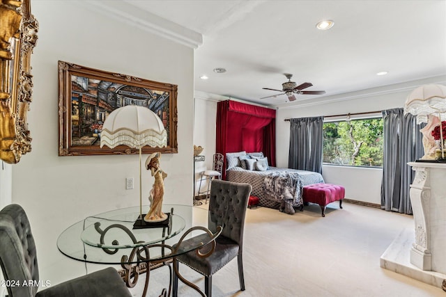 carpeted bedroom with ceiling fan and crown molding