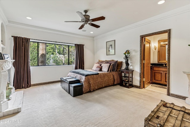 carpeted bedroom featuring connected bathroom, ornamental molding, and ceiling fan