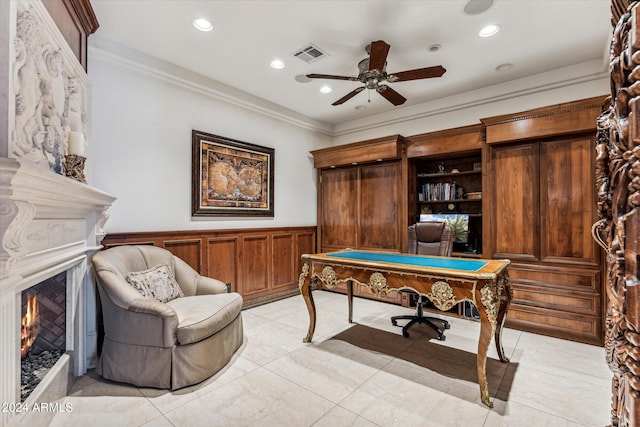 rec room with light tile flooring, ceiling fan, and crown molding