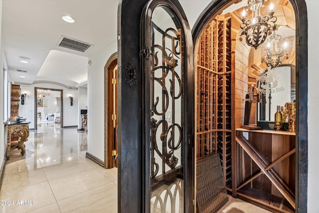 wine cellar featuring a chandelier and light tile flooring