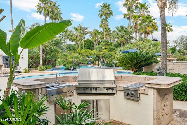 view of patio / terrace featuring area for grilling and a grill