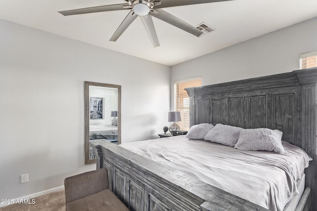carpeted bedroom featuring baseboards, a ceiling fan, and visible vents