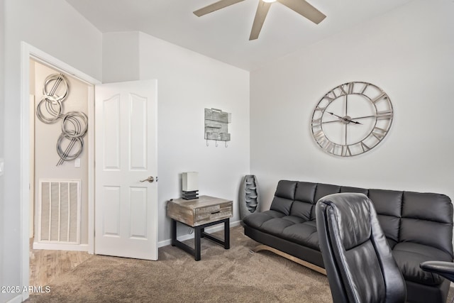 carpeted living area featuring baseboards, a ceiling fan, and visible vents