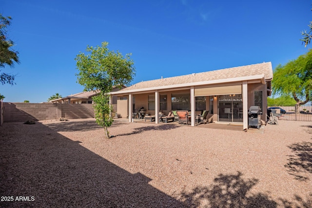 rear view of house featuring a patio area and a fenced backyard