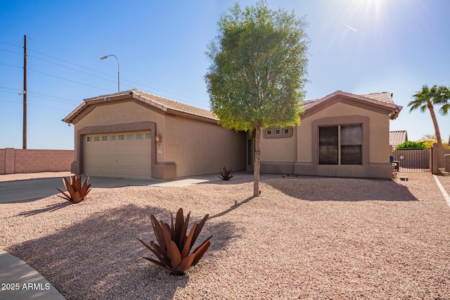 ranch-style home with driveway, a tiled roof, fence, a garage, and stucco siding