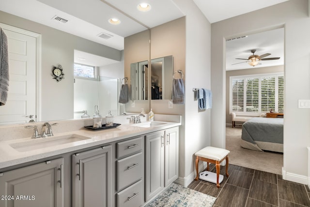 bathroom featuring ceiling fan, vanity, and a healthy amount of sunlight