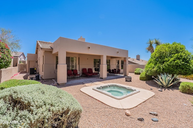 14806 E Lookout Ledge, Fountain Hills, AZ 85268 - rear view of house featuring a patio, stucco siding, an in-ground hot tub, fence, and a chimney