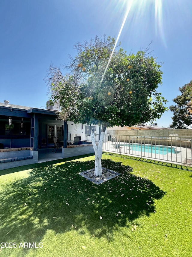view of yard with a fenced in pool and fence