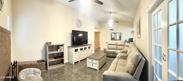 living room with dark tile patterned floors, visible vents, high vaulted ceiling, and a ceiling fan