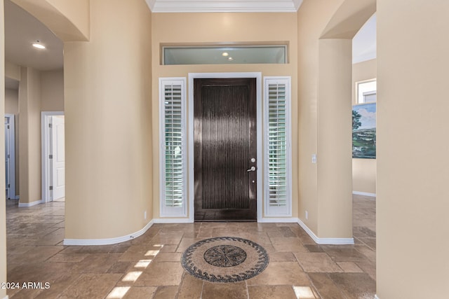 entryway featuring ornamental molding