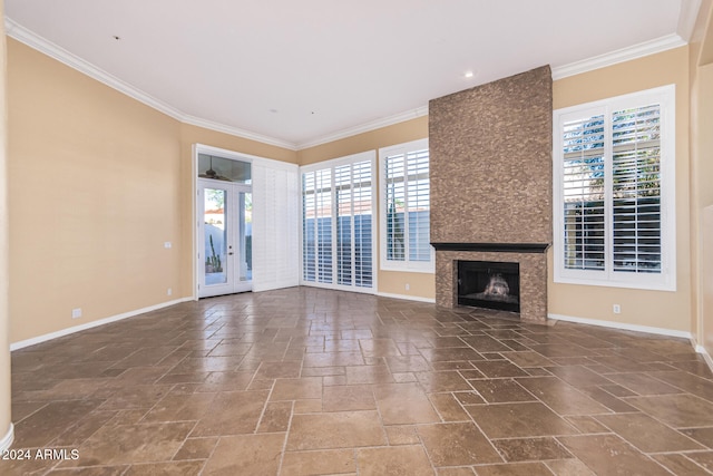 unfurnished living room featuring a fireplace, french doors, and ornamental molding