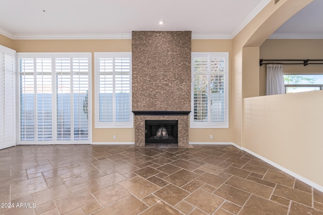 unfurnished living room with a large fireplace and ornamental molding