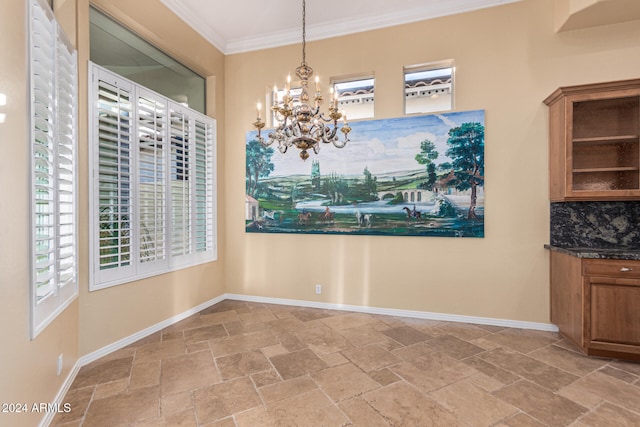 unfurnished dining area with a notable chandelier and crown molding