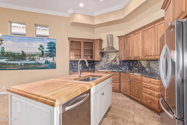 kitchen with sink, stainless steel appliances, wall chimney range hood, wood counters, and decorative backsplash