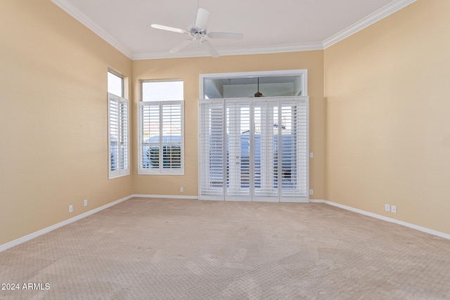 carpeted empty room with ceiling fan and ornamental molding